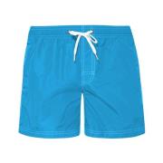 Kort shorts i ensfarget med sterke farger og termosveisede glidelåslom...