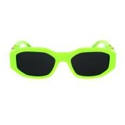 Solbriller med uregelmessig form i fluorescerende grønt og mørkegrått
